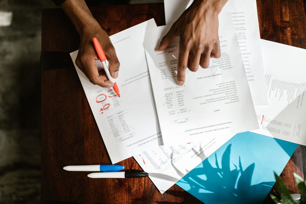 Person reviewing tax documents and forms at a desk
